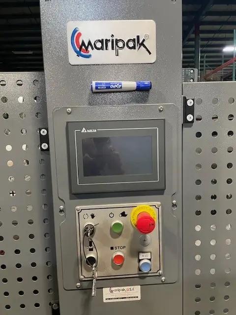 Control panel of a Maripak machine featuring a digital display, buttons, and a key switch. The Maripak logo is above the panel, with a blue and white marker on top.