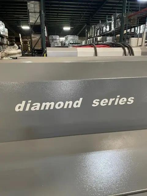 Close-up of a Maripak Diamond Series machine in a warehouse, surrounded by shelves and equipment.