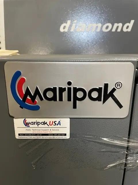 Close-up of a Maripak machine with "diamond" text above and "Maripak USA" label below, displaying contact information for parts and technical support.