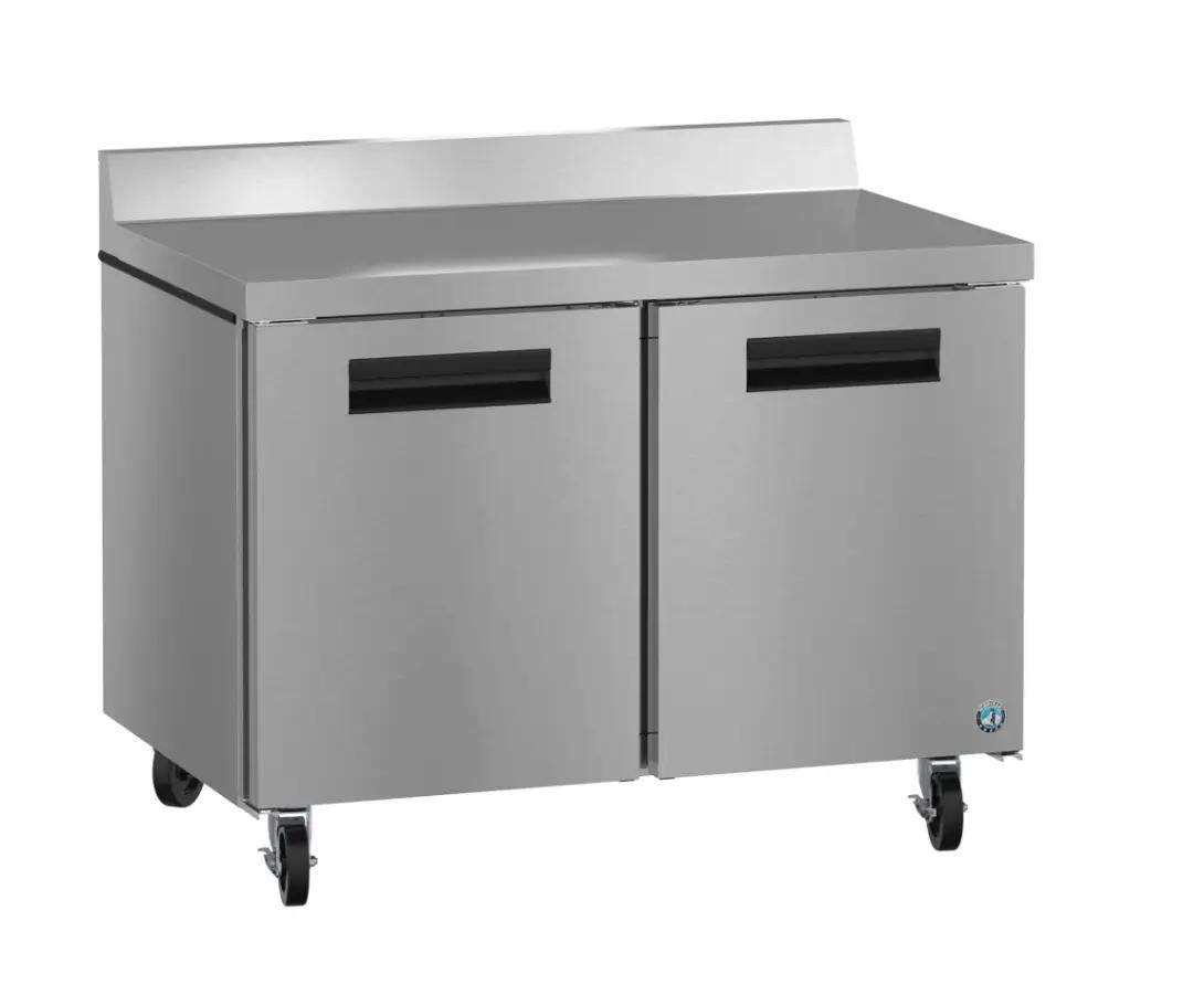 Alt-text: Stainless steel commercial refrigerator with two doors and wheels, suitable for a professional kitchen setting.