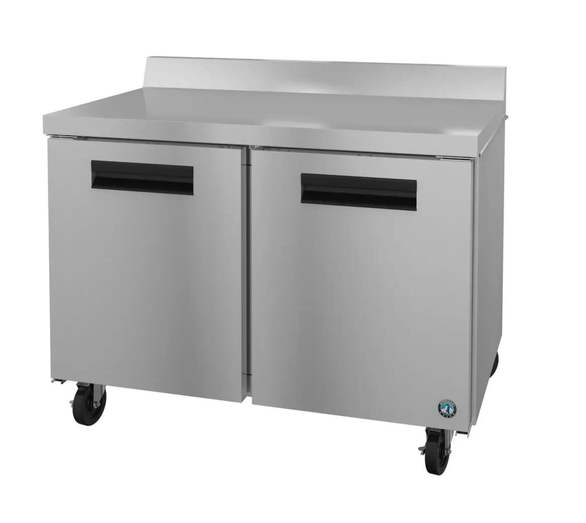 Stainless steel undercounter refrigerator on wheels with two doors and a backsplash.
