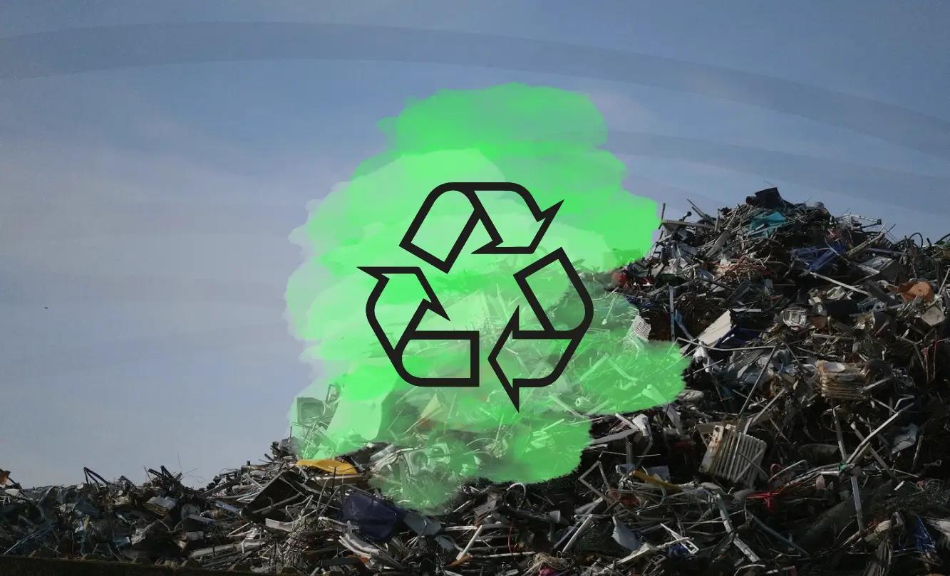 Image of a large pile of scrap metal with a green recycling symbol overlay, set against a clear sky, symbolizing recycling and sustainability.