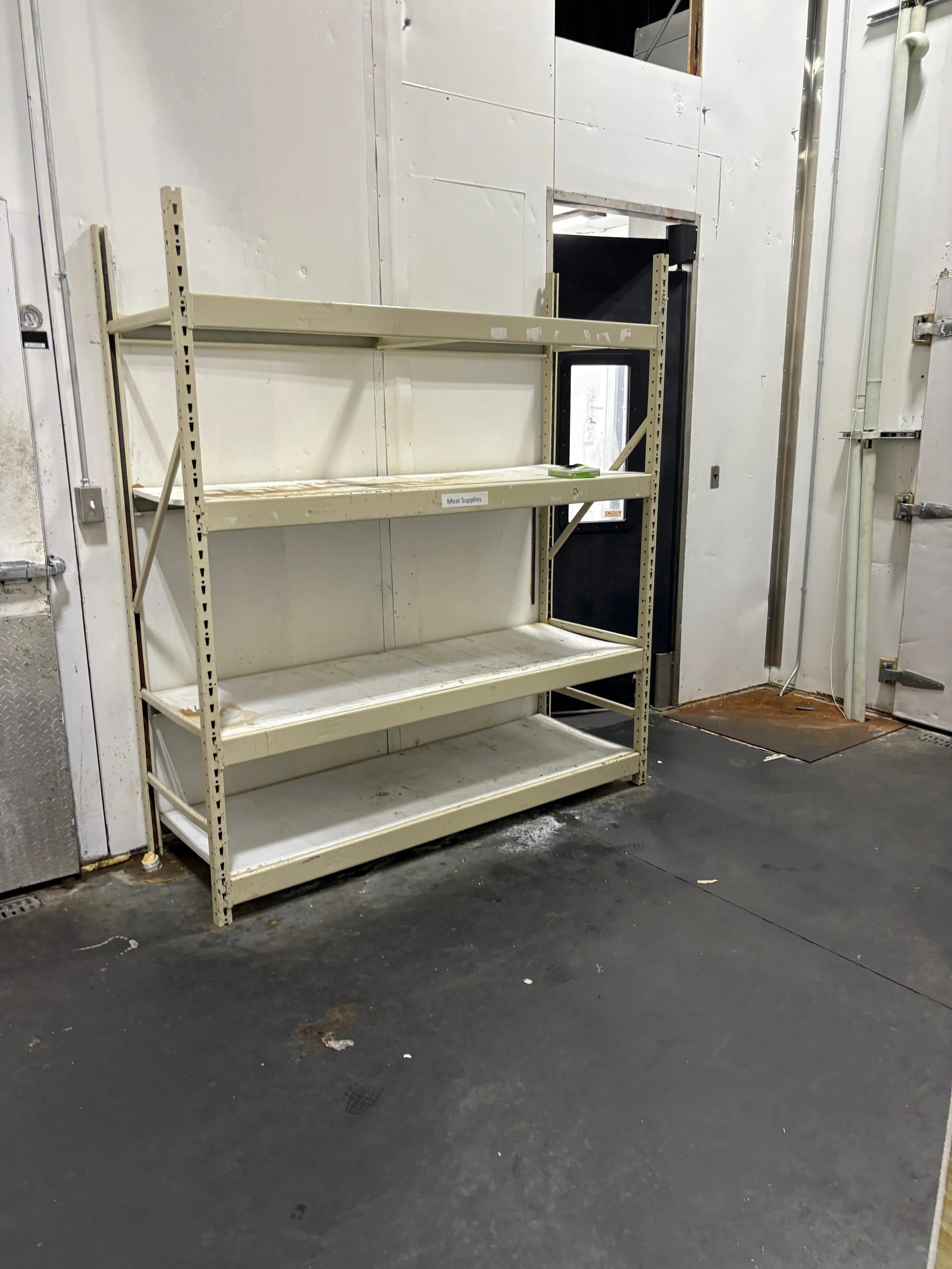Used pallet racking inside a food distribution facility, heavy-duty warehouse storage racks available through Mid-America Store Fixtures