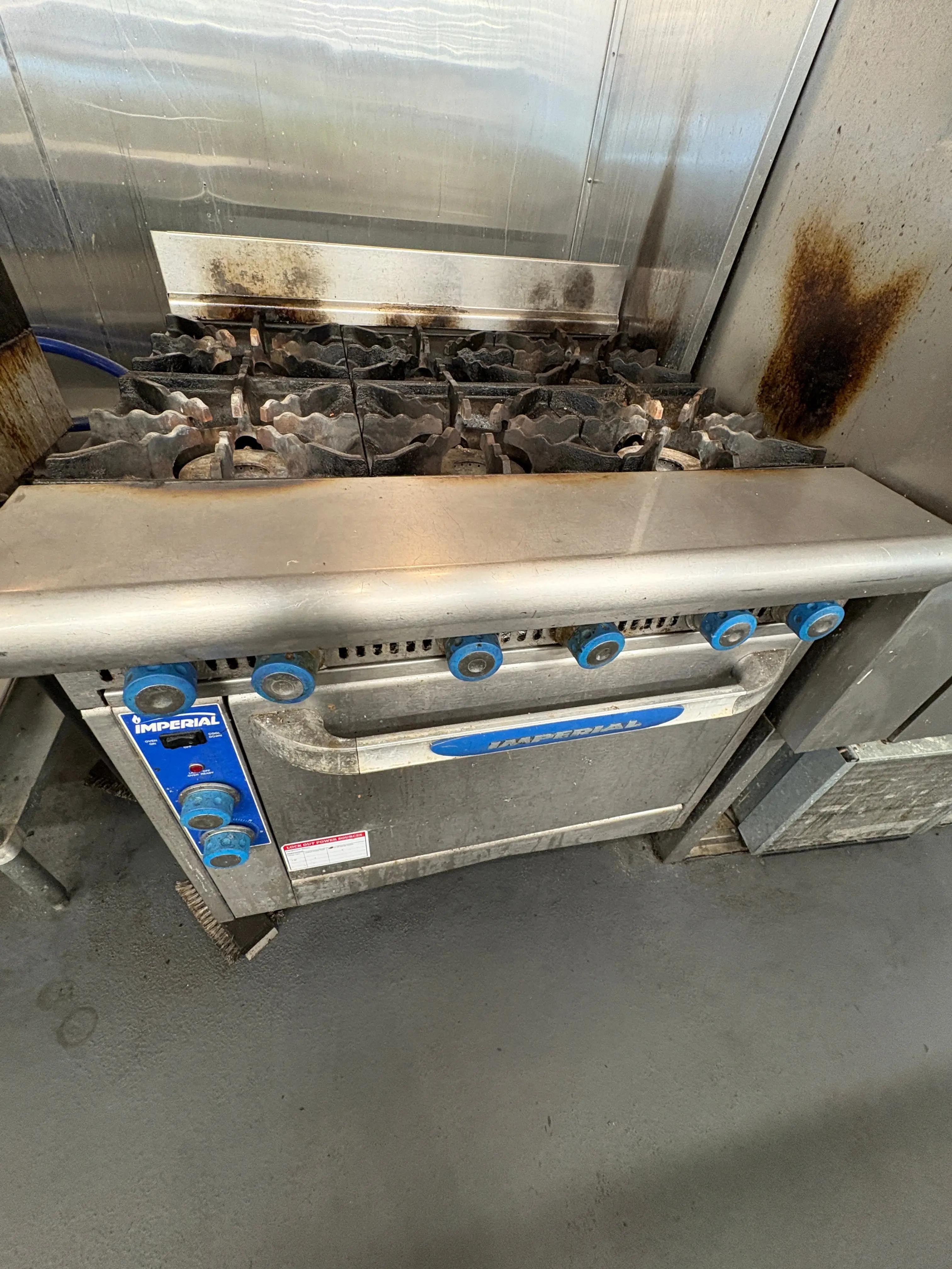 Commercial gas range oven with multiple burners, heavy-duty kitchen cooking equipment used in food service operations