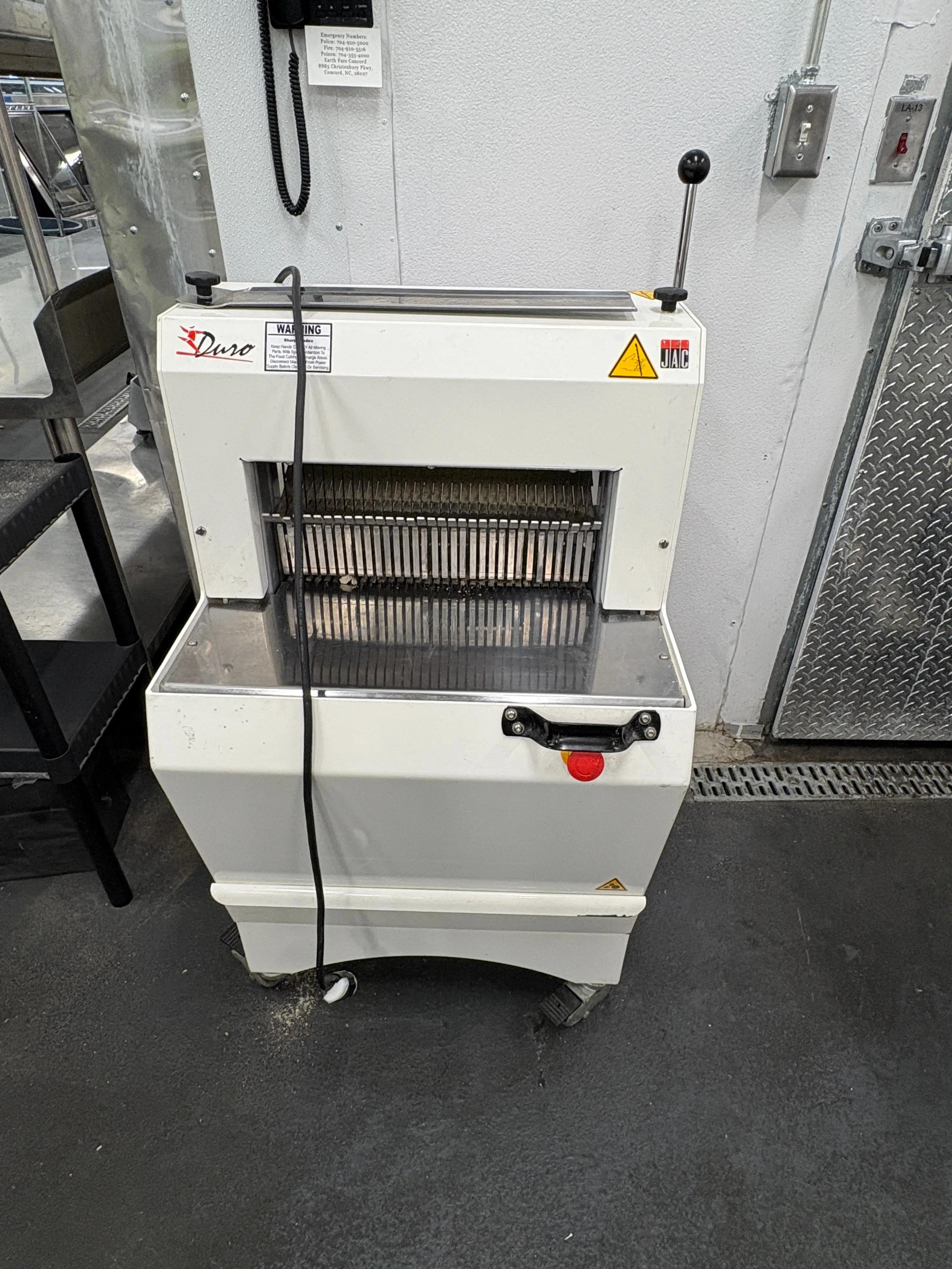 Commercial bread slicer used in grocery store bakery operations, heavy-duty bakery equipment available through Mid-America Store Fixtures