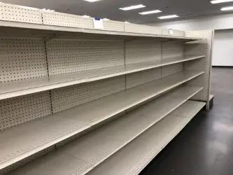Retail store aisle with Lozier gondola shelving for merchandise displays and store fixture organization.