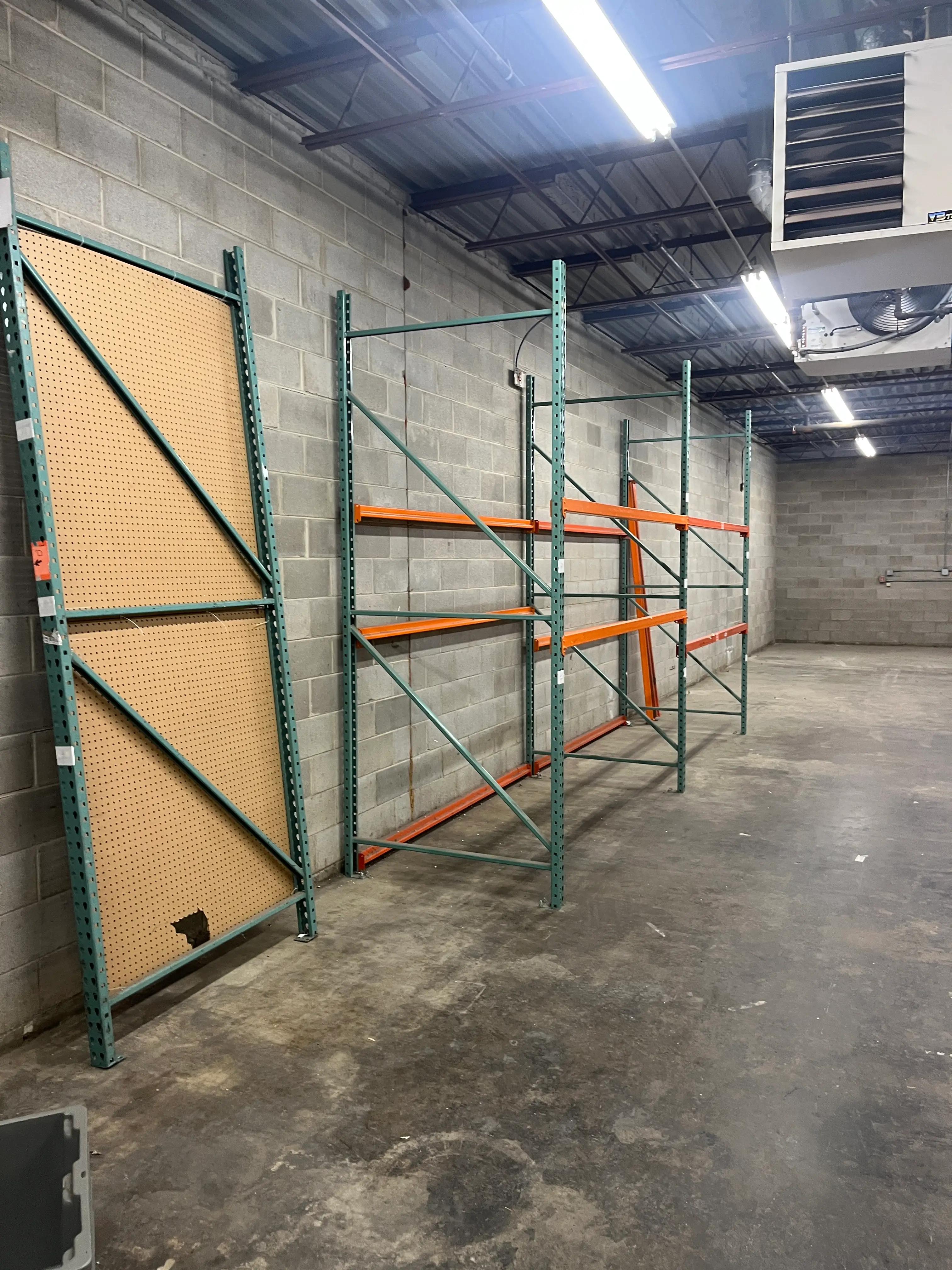 Industrial warehouse interior featuring metal shelving units lined against a concrete block wall, showcasing a project by Mid America.