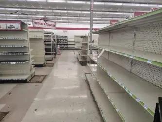 Used Lozier gondola shelving units in retail aisle setup for store fixtures and merchandise display