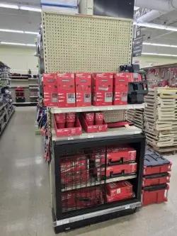 Retail endcap gondola shelving display with pegboard backing for merchandising tools and hardware products