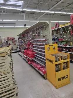 Retail aisle gondola shelving with peg hooks and display racks for hardware store merchandising and product organization