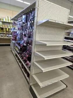 Lozier gondola shelving unit with adjustable shelves and pegboard backing for retail merchandise display