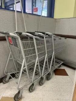 Metal retail shopping carts nested together for grocery store customer use and store fixture liquidation