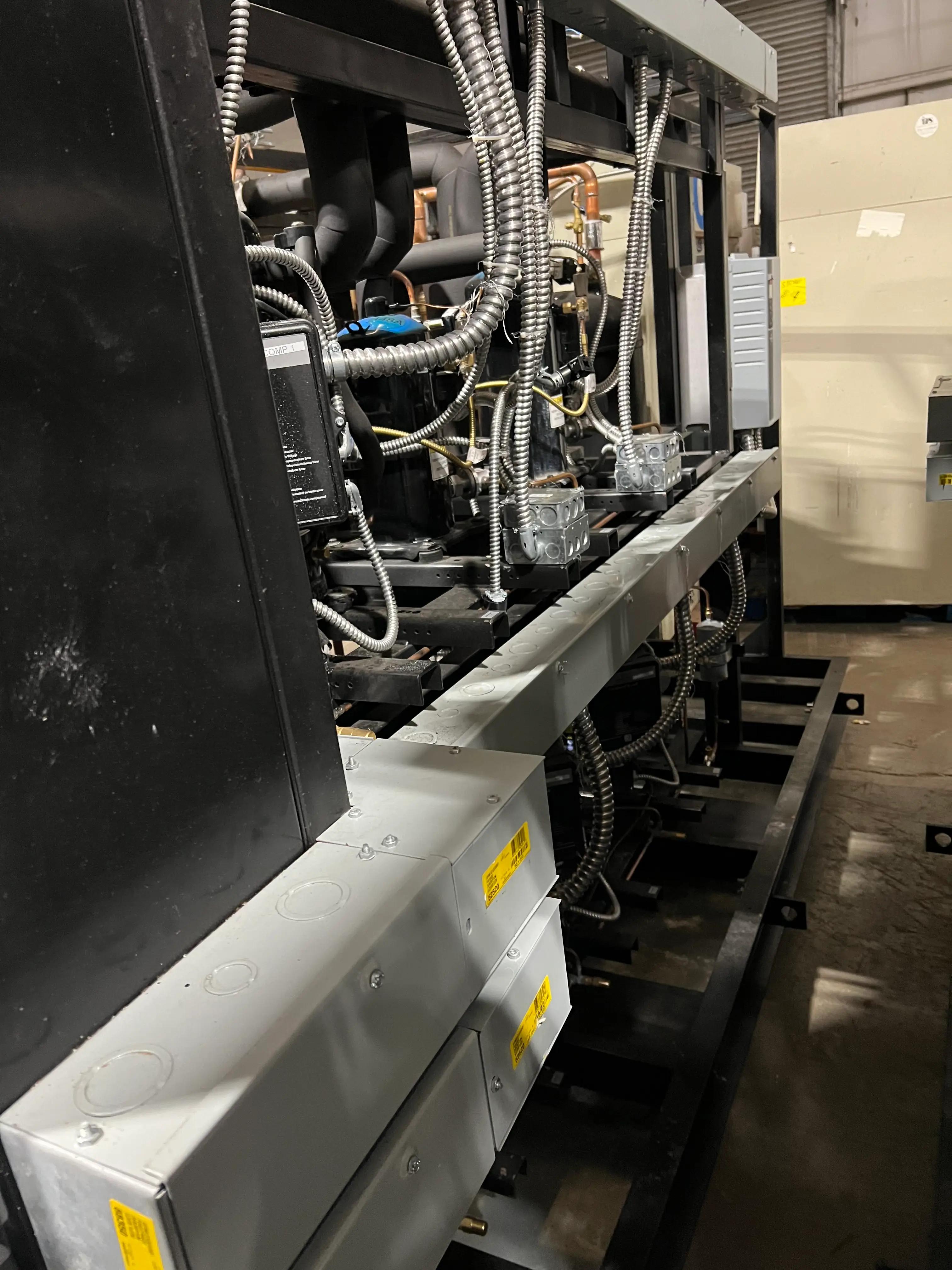 Image of industrial equipment, showing wiring, metal pipes, and components inside a facility.