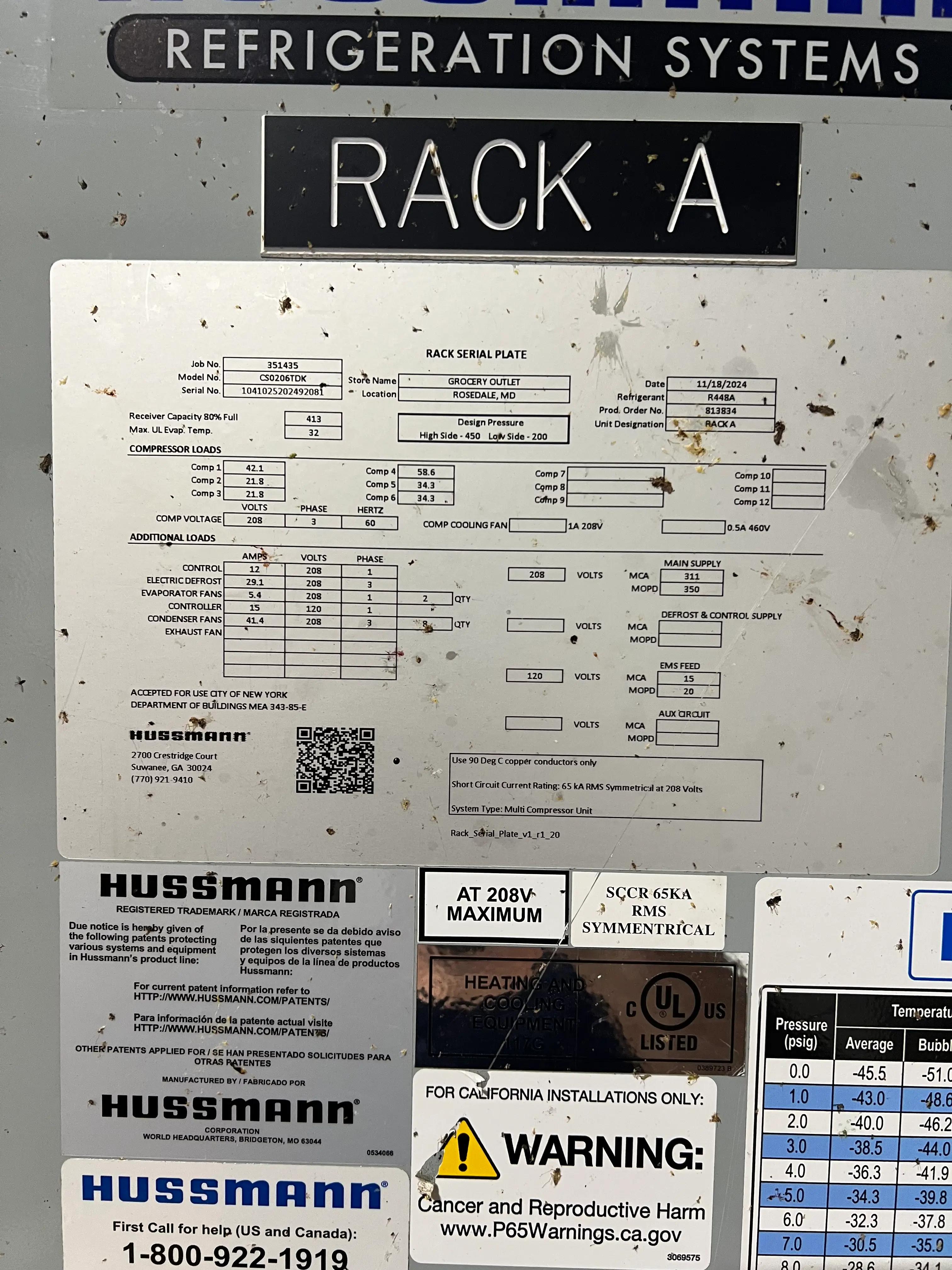 Image showing a serial plate on a Hussmann refrigeration rack labeled 'Rack A', with various technical and safety details.