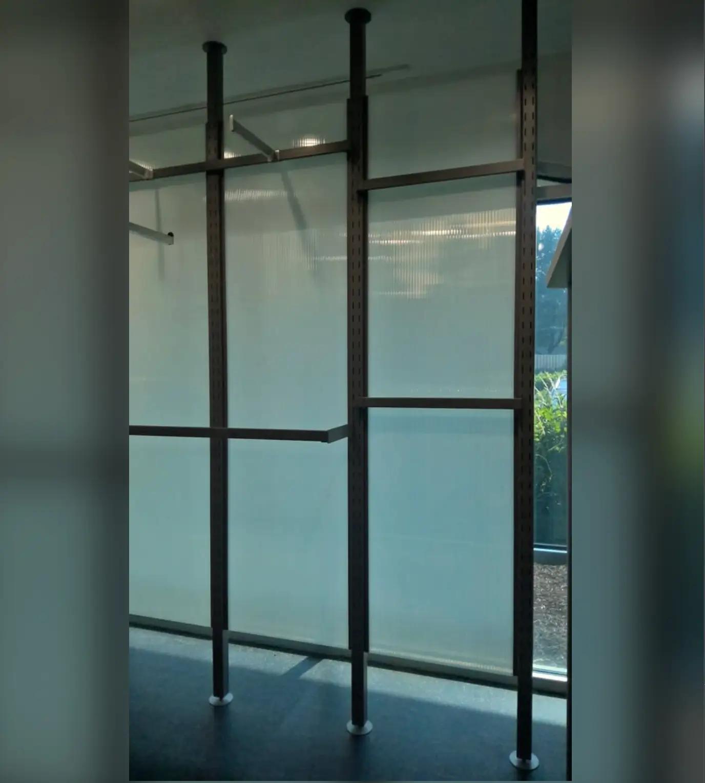 Metal framework installed in front of a translucent panel, showcasing a structural design by Mid America.