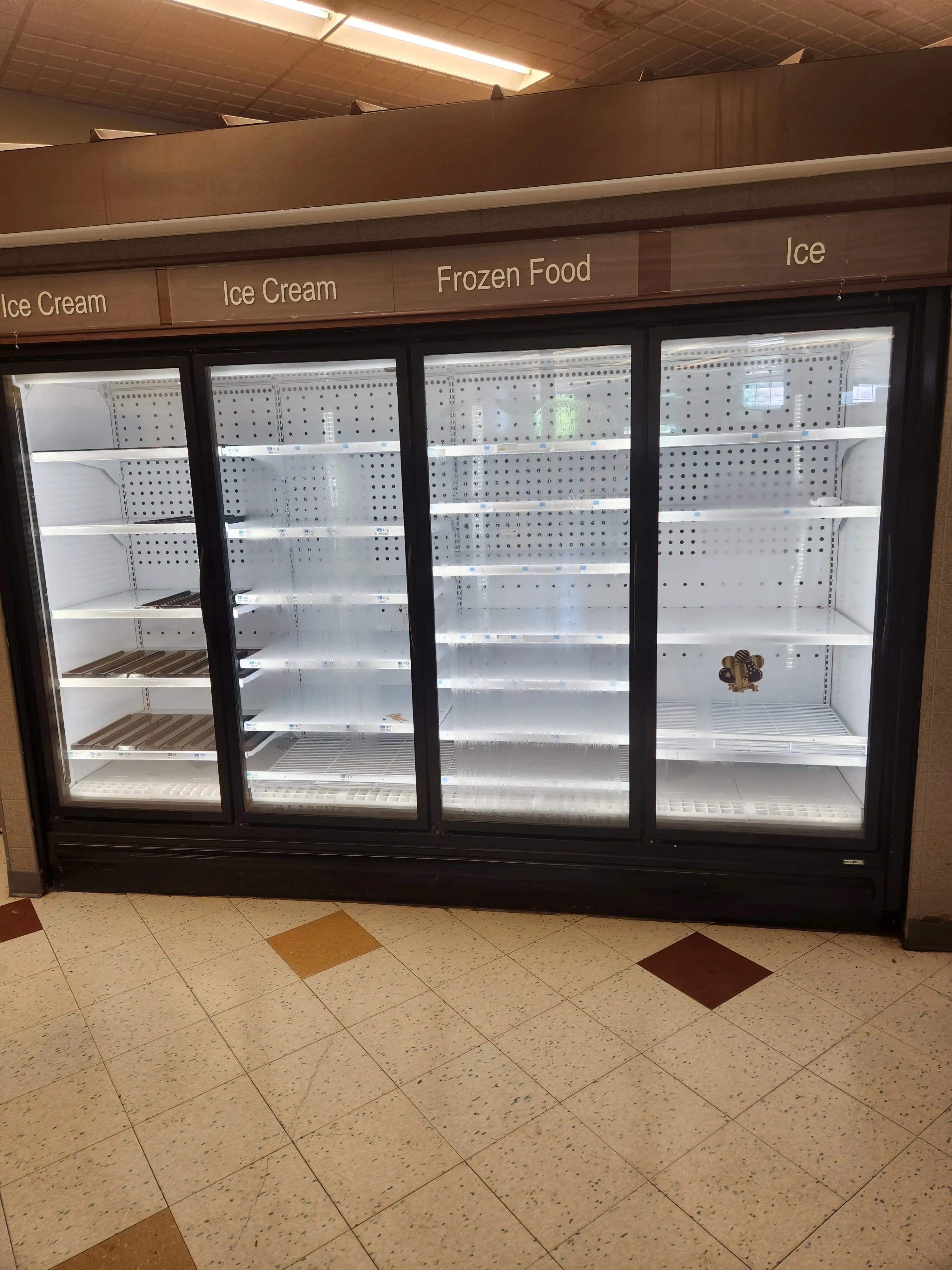 A commercial freezer with labeled sections for Ice Cream, Frozen Food, and Ice, displaying empty shelves.